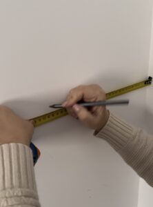 Marca de referencia con lápiz sobre pared blanca